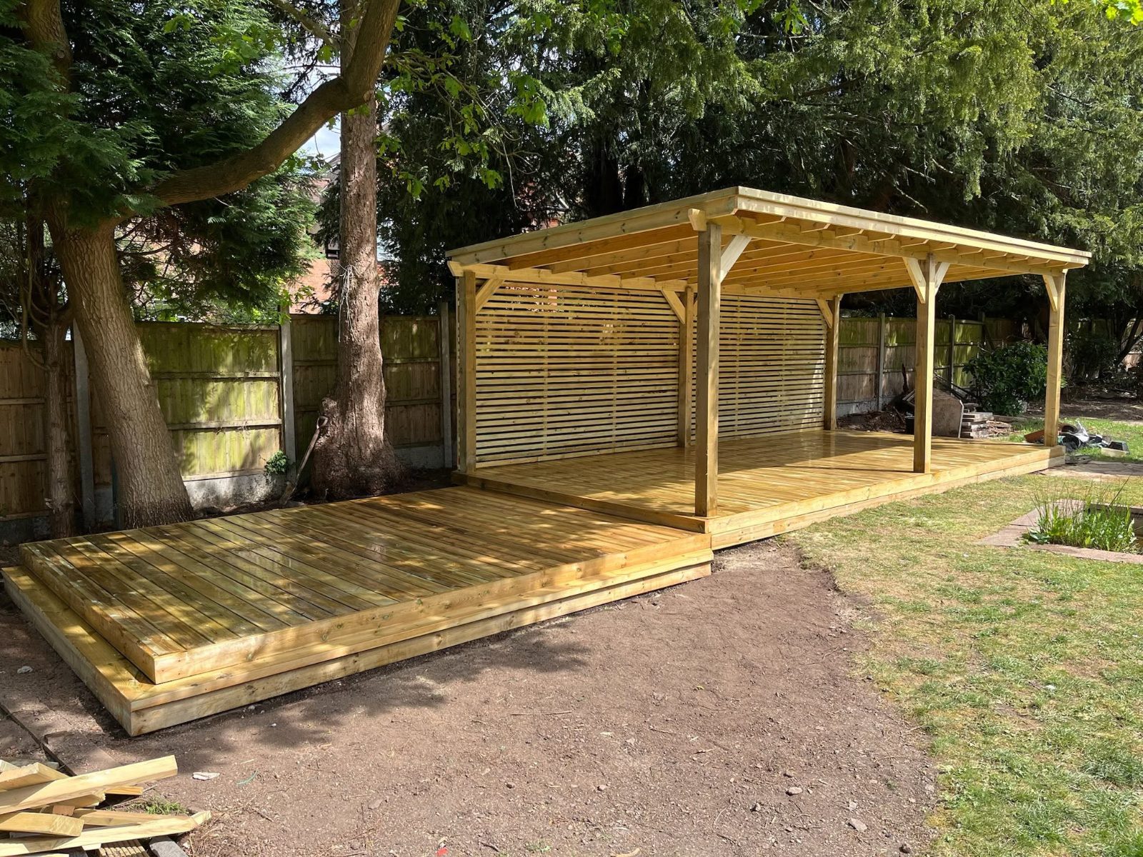 Covered deck with slatted screen under mature trees